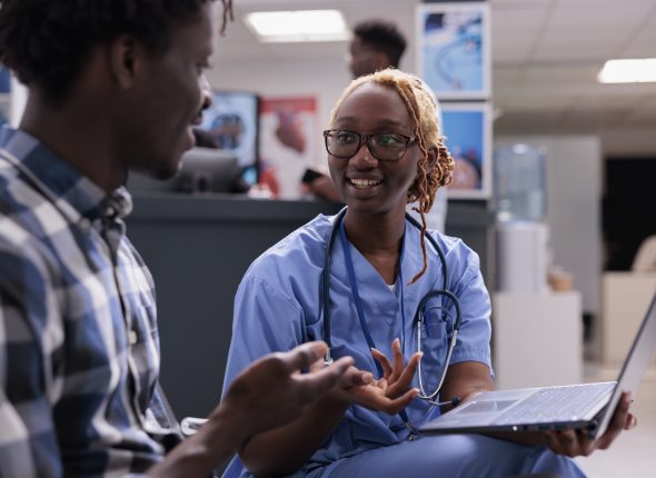 Woman nurse consulting patient at clinic